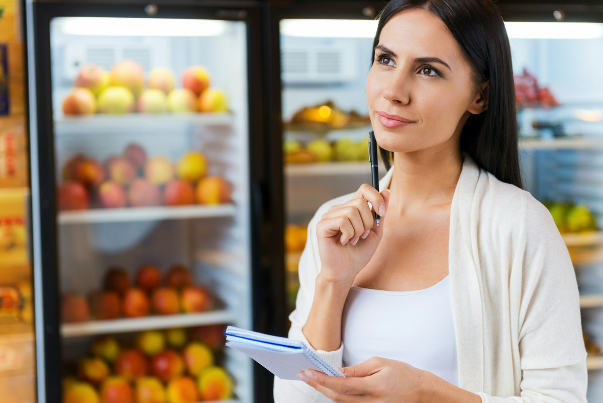 Small business owner in a café with commercial refrigeration